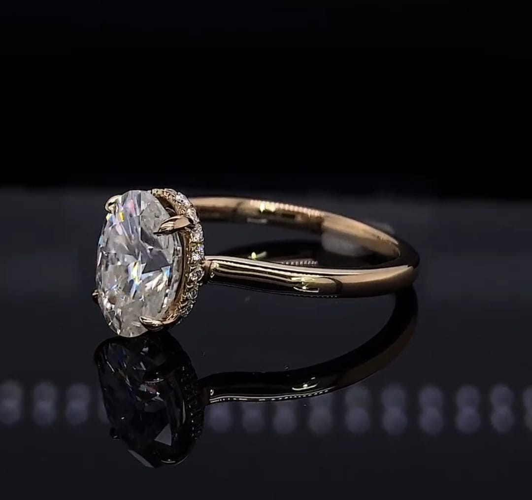 Three-quarter angled view of a 2 CT oval lab grown diamond engagement ring featuring a polished plain metal band.