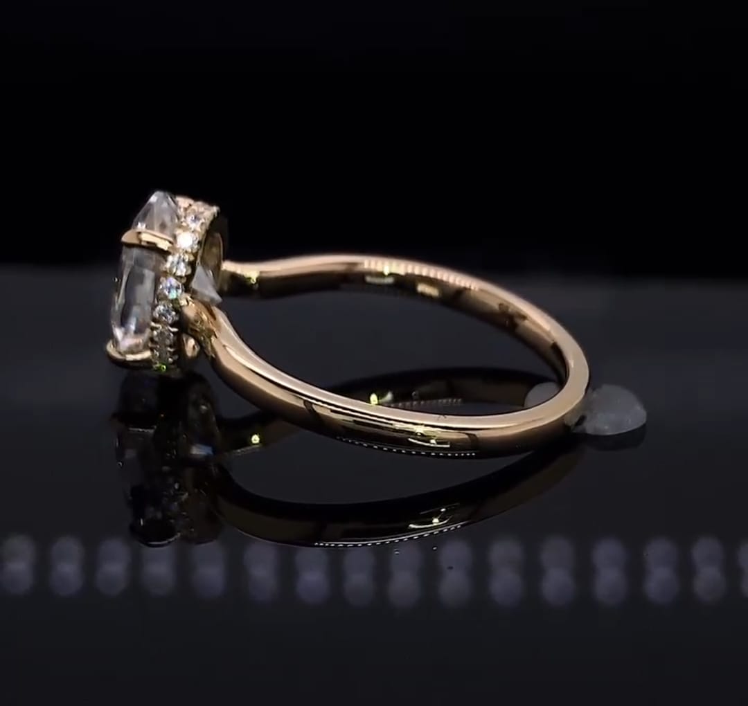 Low angle profile view detailing the structural gallery and sparkling hidden halo of an oval cut lab grown diamond ring.