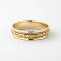 Front angle view of men's yellow gold wedding band featuring a woven braid center and twisted rope borders.