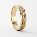 Side perspective view of a men's yellow gold wedding band with braided center weave and twisted cable edges.