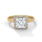 Top-down view of a 3 CT princess cut lab grown diamond engagement ring with a micro-pavé halo border set on a smooth yellow gold band.