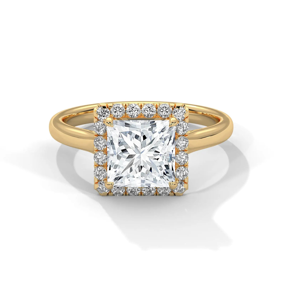 Top-down view of a 3 CT princess cut lab grown diamond engagement ring with a micro-pavé halo border set on a smooth yellow gold band.