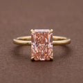 Front studio view of a 4 CT fancy pink radiant cut lab grown diamond ring set in 14K yellow gold.