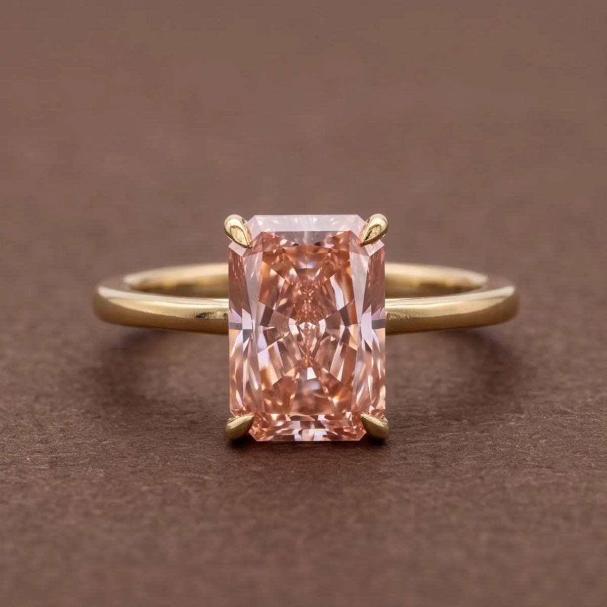 Front studio view of a 4 CT fancy pink radiant cut lab grown diamond ring set in 14K yellow gold.