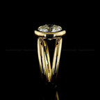 Side profile view of a 4 CT round cut lab grown diamond engagement ring with a modern yellow gold bezel setting and split shank design.