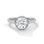 Top angle view of a 3 CT round cut lab grown diamond in a polished white gold bezel setting with diamond pavé rim.