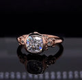 Direct top view of a 2 CT cushion cut lab grown diamond engagement ring featuring a vintage bezel setting and ornate rose gold scrollwork.