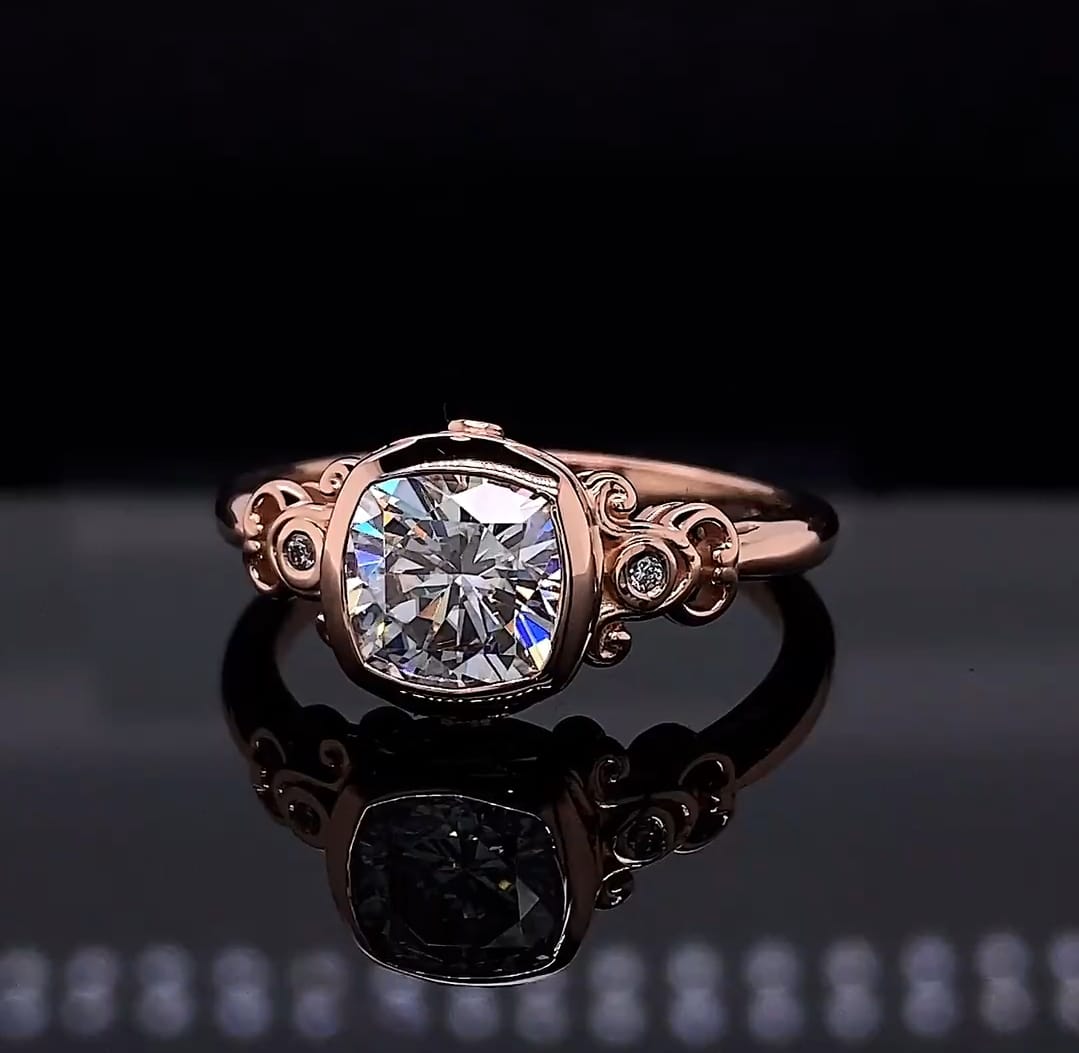 Direct top view of a 2 CT cushion cut lab grown diamond engagement ring featuring a vintage bezel setting and ornate rose gold scrollwork.