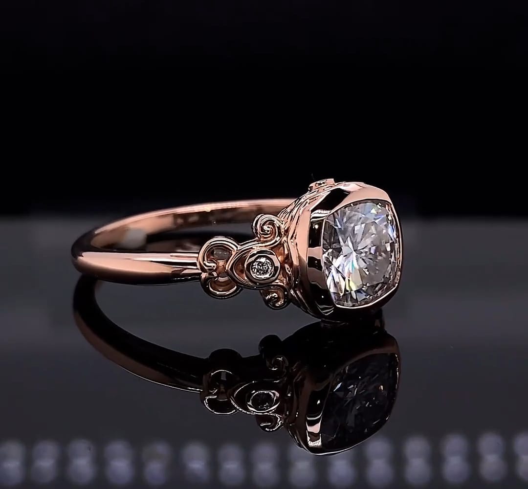 Three-quarter angled view of a 2 CT cushion cut lab grown diamond ring resting on a black reflective surface, showcasing its vintage band.