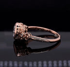 Low angle profile view detailing the intricate floral scrollwork, side diamond accents, and secure bezel setting of a cushion cut engagement ring.