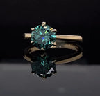Top view of a 3 CT green round cut moissanite solitaire engagement ring in yellow gold