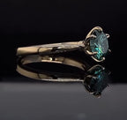 Side profile view showing the delicate prongs of a 3 carat green round moissanite ring