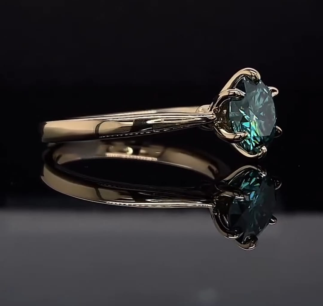 Side profile view showing the delicate prongs of a 3 carat green round moissanite ring