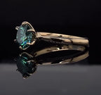 Angled perspective showcasing the brilliant scintillation of a green round cut moissanite ring