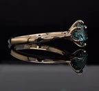 Elegant side angle of the 3 CT green round moissanite ring in polished yellow gold