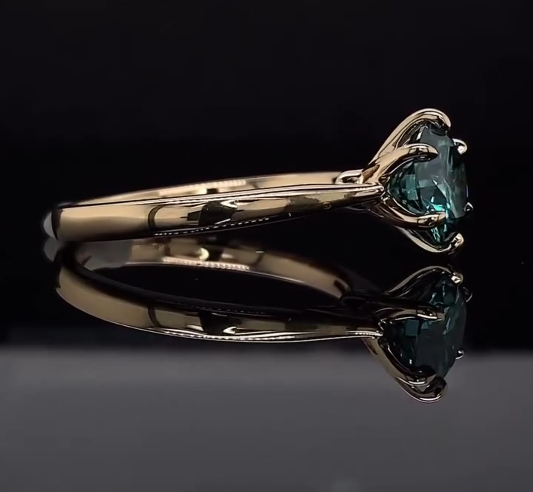 Elegant side angle of the 3 CT green round moissanite ring in polished yellow gold