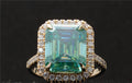 Top-down view showcasing the large 4 CT green emerald cut center stone surrounded by a brilliant halo.