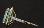 Profile detail of the yellow gold band and stone setting on the 4 CT green emerald cut moissanite ring.