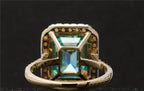 Under-basket and gallery architecture view of the luxury green emerald cut moissanite ring.