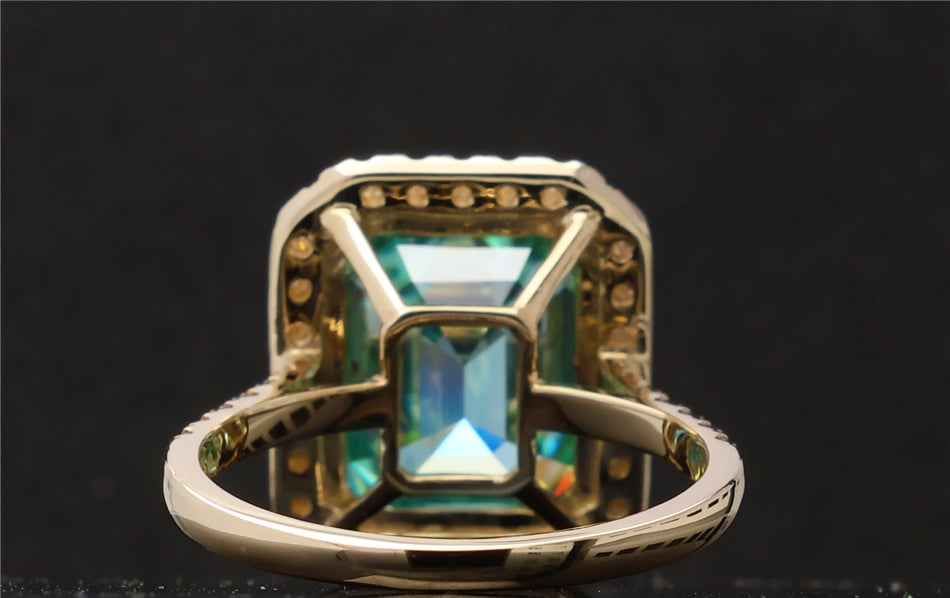 Under-basket and gallery architecture view of the luxury green emerald cut moissanite ring.