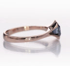 Profile view highlighting the low-profile bezel setting and polished rose gold shank.
