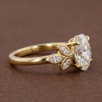 Side profile view showing cathedral basket setting and polished yellow gold band.