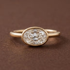 Direct top studio view of a 3 CT horizontally set East-West oval lab grown diamond solitaire ring in a yellow gold bezel.