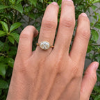 3 CT East-West oval cut lab grown diamond bezel ring worn on hand outdoors.