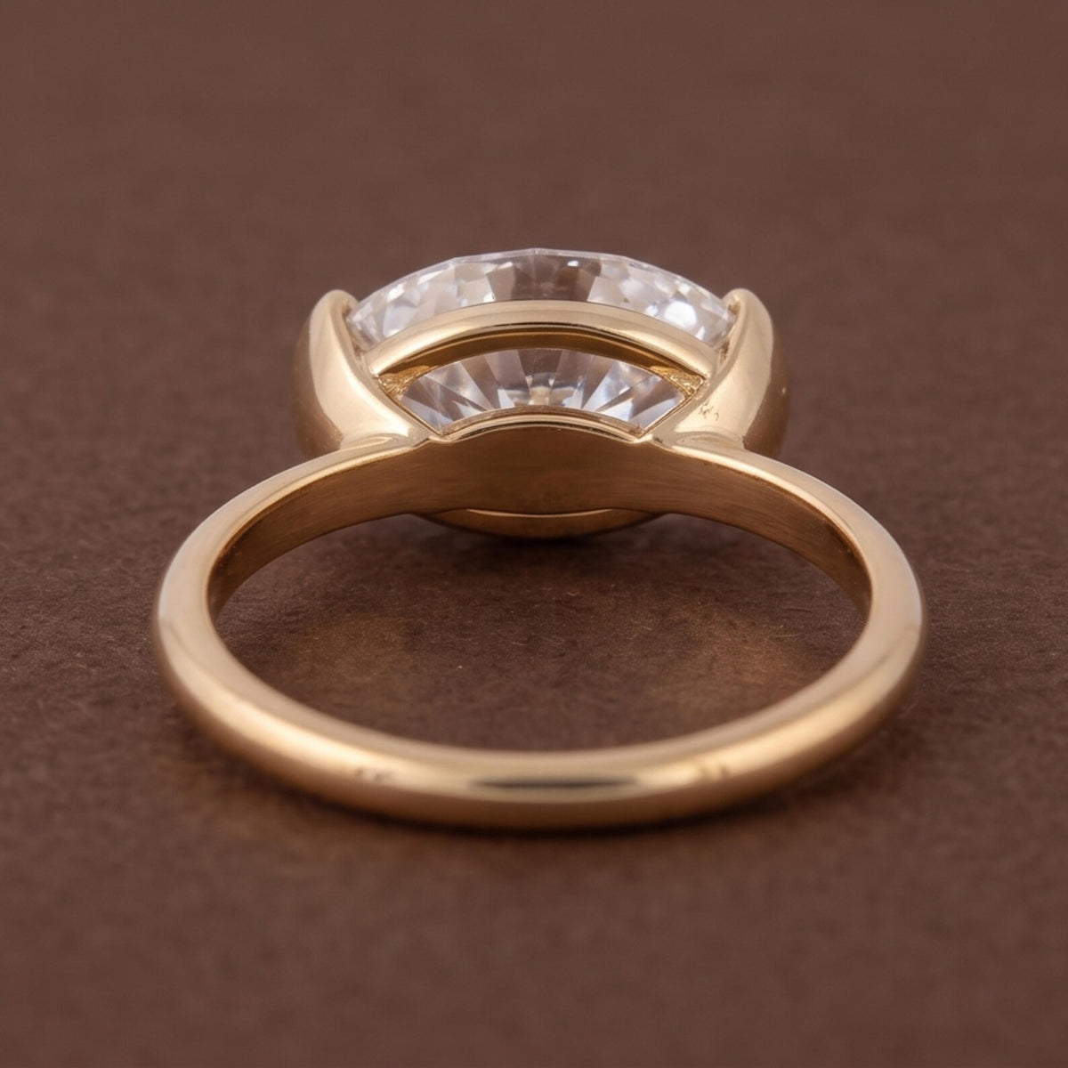 Undergallery perspective view showing open basket construction of a 3 CT oval half bezel ring.