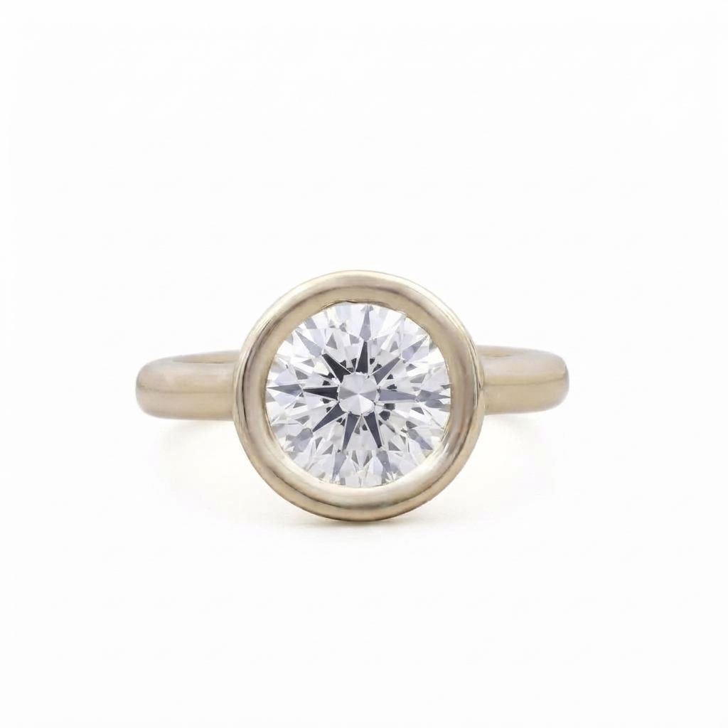 Top-down studio view of a 3 CT round brilliant lab grown diamond in a yellow gold full bezel setting.