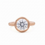 Direct top view of a 3 CT round lab grown diamond bezel engagement ring crafted in rose gold.