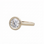 Three-quarter side profile view of a modern 3 CT round lab grown diamond solitaire bezel ring.
