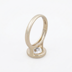 Upright side profile view showing open side gallery structure and 14KT hallmark inside yellow gold band.