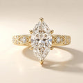 Front view of a 4 CT marquise cut lab grown diamond ring with intricate milgrain filigree and diamond accents on a yellow gold band.
