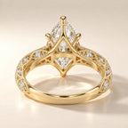Detailed undergallery view showing open lattice gallery and milgrain design on a 4 CT marquise lab diamond yellow gold ring.