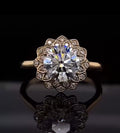 Direct top-down view of a 3 CT round cut lab grown diamond engagement ring featuring a stunning floral scalloped diamond halo.