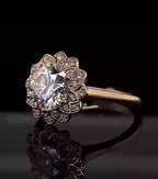Three-quarter angled view highlighting the spectacular sparkle and colorful fire of the 3 carat round cut center stone and floral halo.