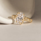 Studio perspective view highlighting the 4 CT oval cut lab diamond held by organic leaf claws on an engraved yellow gold band.