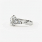 Side profile view showing tapered shoulder accent diamonds and white gold milgrain frame on a 2 CT princess cut ring.