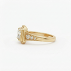 Side perspective view showing smooth band and milgrain tapered shoulders on a yellow gold 2 CT princess cut ring.