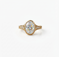Front view of a 4 CT oval lab diamond surrounded by a protective gold bezel with side accent diamonds.