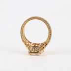 Profile view showing the elaborate filigree wirework undergallery and hand-engraved pattern along the yellow gold ring band.