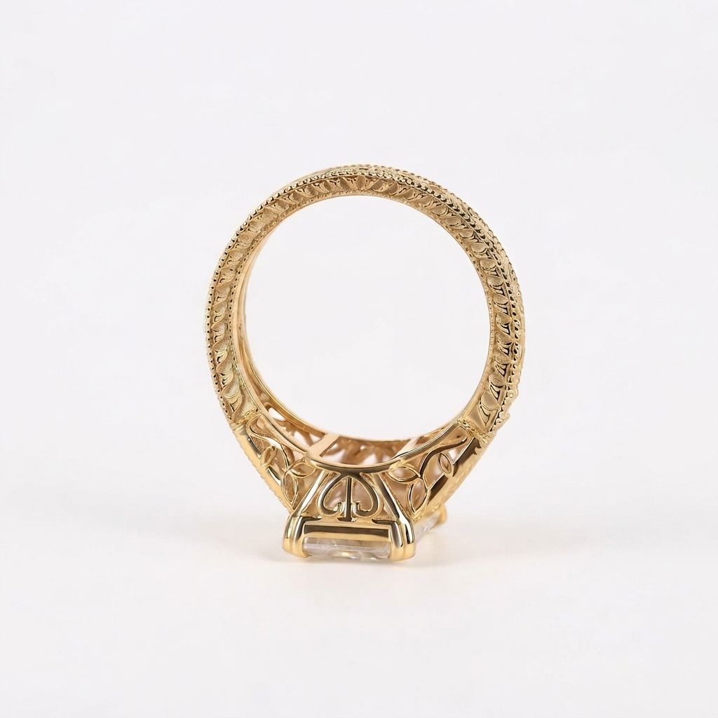 Profile view showing the elaborate filigree wirework undergallery and hand-engraved pattern along the yellow gold ring band.
