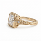 Angled side view of a 4 CT princess cut lab grown diamond ring with hand-engraved yellow gold band, milgrain trim, and side accent stone.