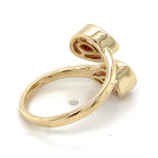 Undergallery view of an open bypass ring revealing teardrop-shaped gallery cutouts beneath both pear bezel settings.