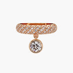 Front view of a rose gold twisted pave diamond band featuring a dangling bezel round lab diamond charm.