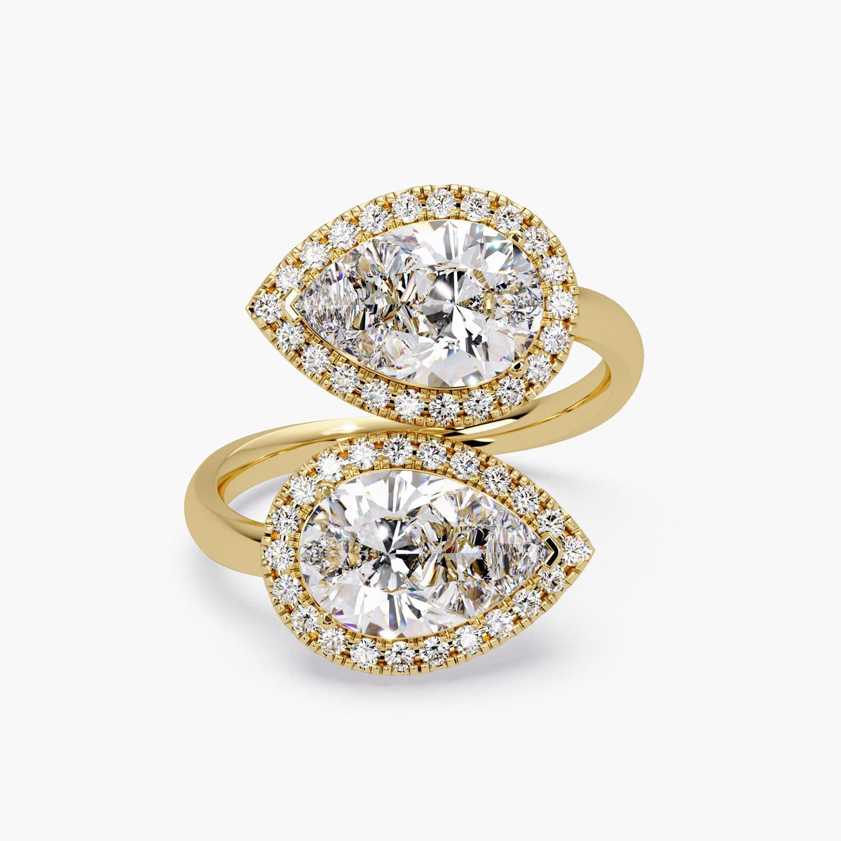 Top view of a 14K yellow gold Toi et Moi bypass ring featuring twin pear cut lab grown diamonds with micro-pavé halos.