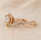 Side profile view of a rose gold 2 CT round lab grown diamond ring with sculpted flower petals and leaf pavé vine shank.