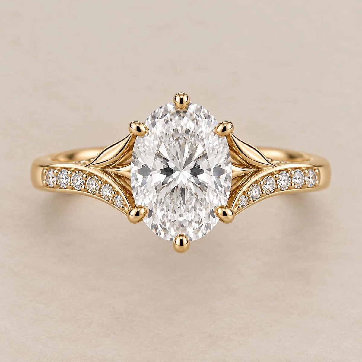 Top view of a 3 CT oval cut lab grown diamond engagement ring with split leaf shoulders and pavé band in yellow gold.