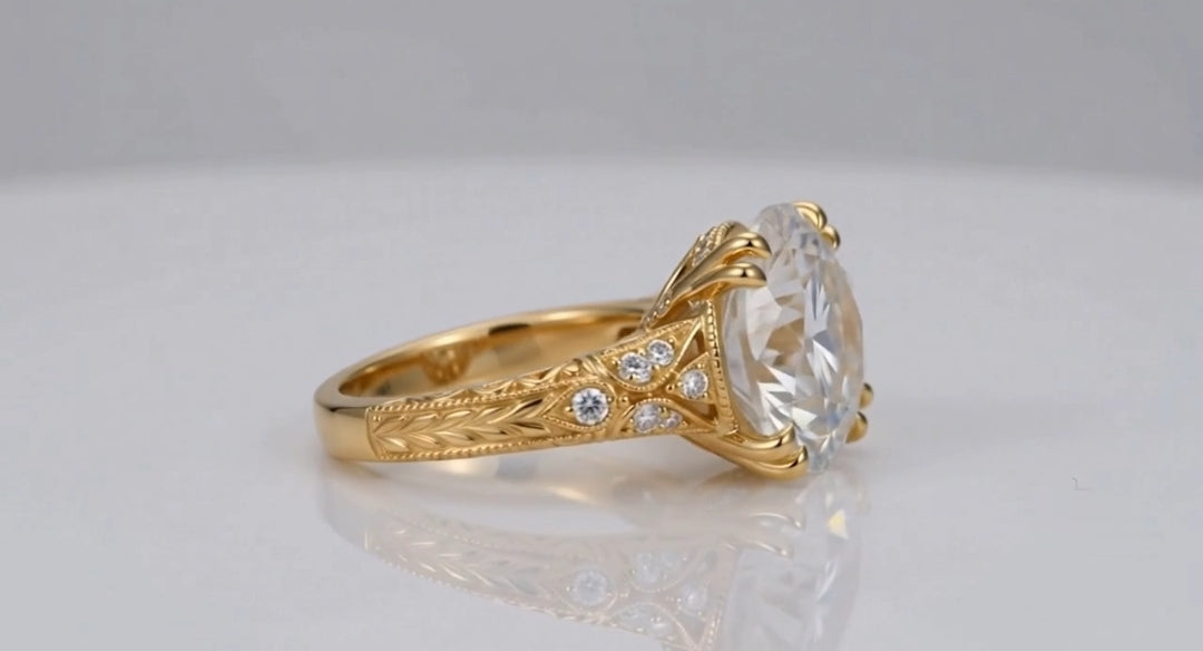 Side profile of a 4 CT round lab diamond set with double claw prongs on a hand-engraved leaf pattern yellow gold shank.